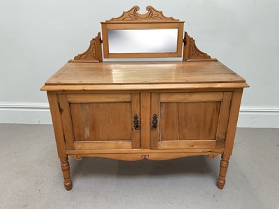Lot 76 - An old pine wash stand with two cupboard doors...