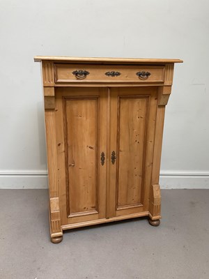 Lot 61 - A Continental pine cupboard with single drawer...
