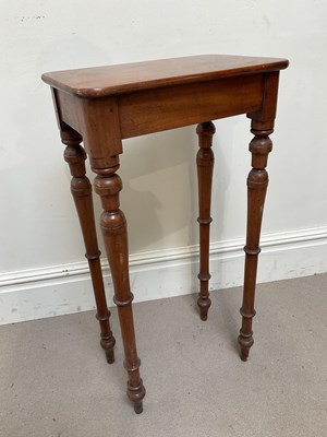 Lot 1284 - A tall mahogany occasional table, on turned...