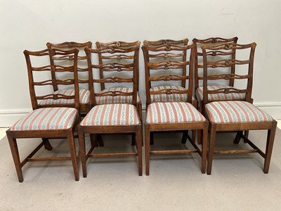 Lot 49 - A set of eight oak ribbon ladder back chairs.