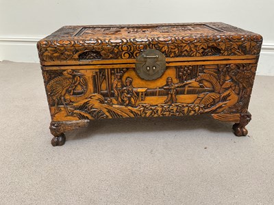 Lot 1199 - A reproduction carved camphor wood chest,...