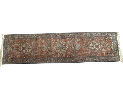 Lot 2173 - An orange ground hand knitted woollen Eastern...