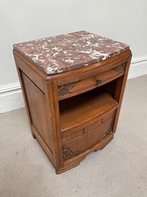 Lot 257 - A Continental oak marble top bedside cabinet,...