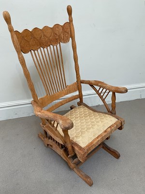 Lot 77 - An early 20th century oak rocking chair,...
