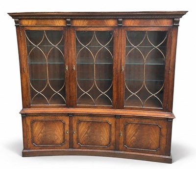 Lot 73 - A reproduction mahogany three door bookcase,...