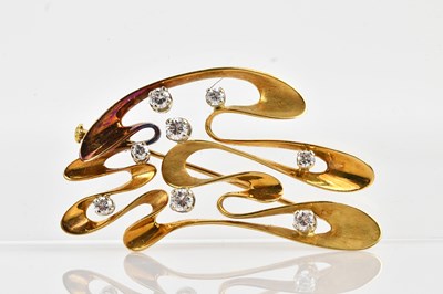 Lot 116 - An 18ct yellow gold diamond set wave brooch,...