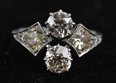 Lot 379 - An Art Deco diamond dress ring set with four...