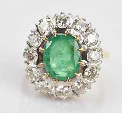 Lot 376 - A diamond and emerald cluster dress ring, the...