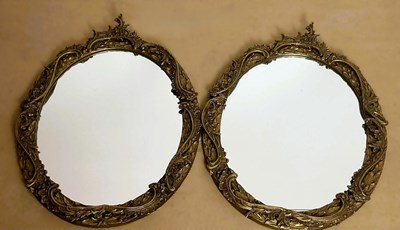Lot 784 - A pair of ornate Rococo style French gilt oval...