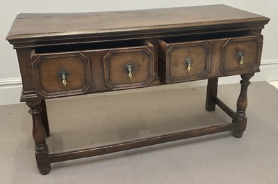 Lot 1193 - An early 20th century oak two drawer dresser,...