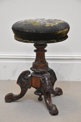 Lot 1286 - A Victorian carved walnut revolving piano...