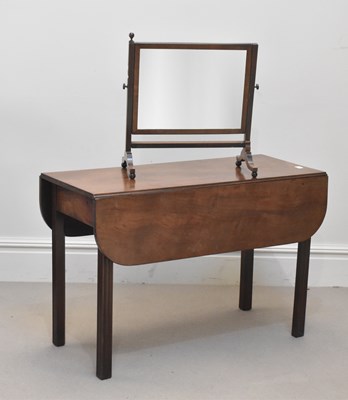 Lot 1319 - A Georgian mahogany drop-leaf dining table on...