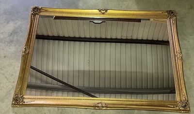 Lot 726 - A large ornately decorated gilt wall mirror,...