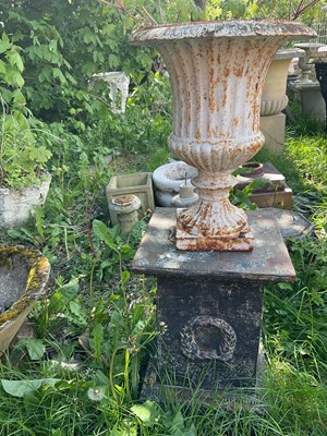 Lot 2148 - A cast iron garden urn, height 46cm, on an...