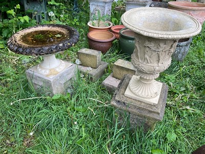 Lot 2153 - A reconstituted garden urn, decorated with...