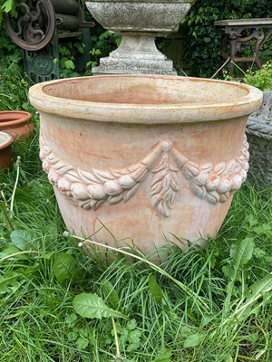 Lot 2163 - A large terracotta garden planter, with swag...