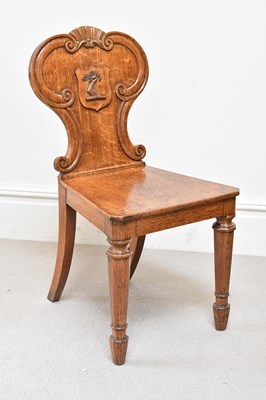 Lot 203 - An early 20th century oak hall chair.