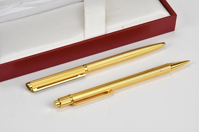 Lot 1285 - MUST DE CARTIER; a gold plated pencil and a...