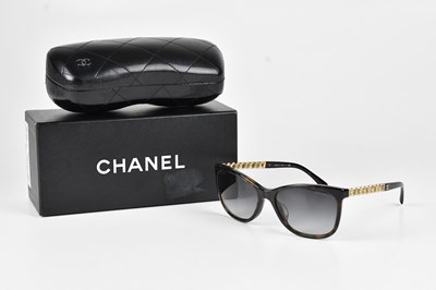 Lot 1251 - CHANEL; a pair of brown tortoiseshell...