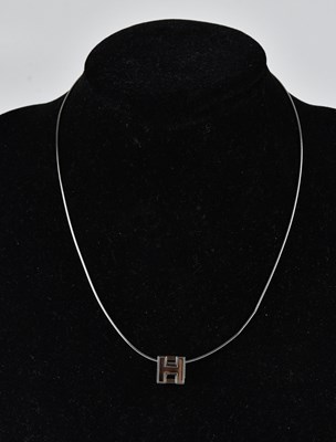 Lot 1435 - HERMÈS; a silver Cage d'Ache cube necklace,...