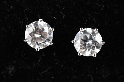 Lot 163 - A pair of 18ct white gold diamond solitaire...