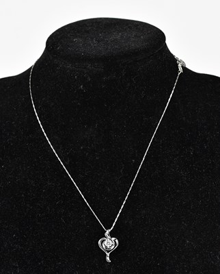 Lot 249 - An 18ct white gold diamond set pendant on a...