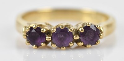 Lot 482 - A 9ct yellow gold amethyst three stone dress...