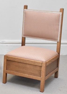 Lot 1305 - An early 20th century oak nursing chair with...