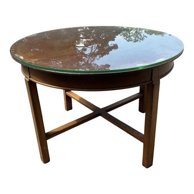 Lot 1312 - A mahogany circular coffee table with glass...