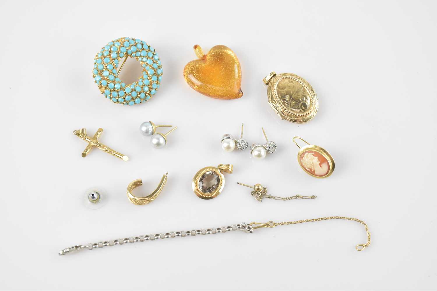 Lot 16 - A yellow metal mounted pendant set with an...