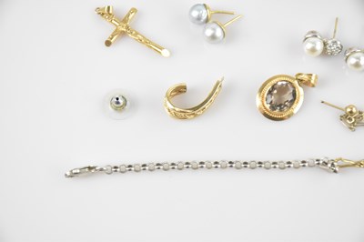 Lot 16 - A yellow metal mounted pendant set with an...