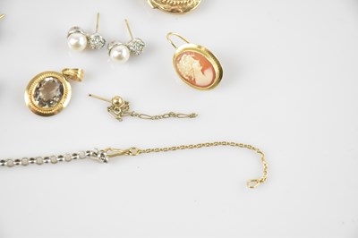 Lot 16 - A yellow metal mounted pendant set with an...