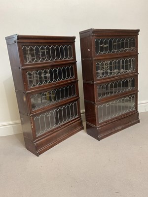 Lot 2004 - GLOBE WERNICKE; a pair of oak four section...