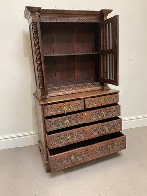 Lot 2003 - A George III and later carved oak cupboard on...