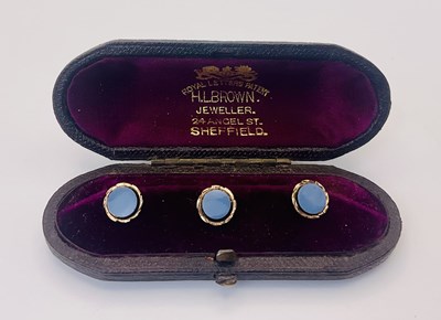 Lot 699 - A cased set of three yellow metal dress studs...