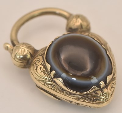 Lot 1351 - A Victorian yellow metal agate set heart...