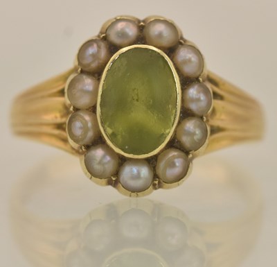 Lot 1255 - An 18ct yellow gold peridot and seed pearl set...