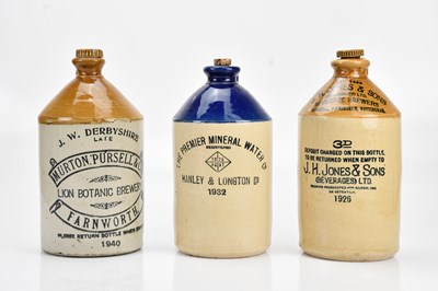 Lot 473 - Three advertising stoneware flagons comprising...