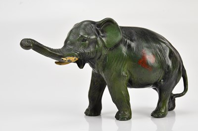 Lot 1183 - A Japanese green painted base metal figure of...