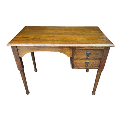 Lot 70 - An Edwardian Arts and Crafts style oak desk,...