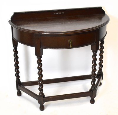 Lot 1616 - An early 20th century oak demi-lune hall table
