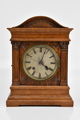 Lot 358 - An early 20th century oak mantel clock, with...