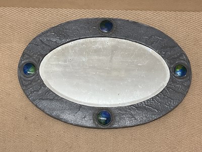 Lot 796 - An Arts and Crafts oval Liberty style wall...