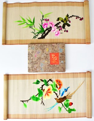 Lot 242 - A silk-covered stamp album containing a...