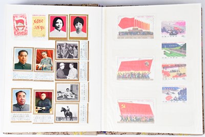 Lot 242 - A silk-covered stamp album containing a...