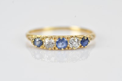 Lot 483 - A diamond and sapphire five stone dress ring,...