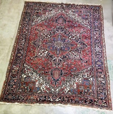 Lot 881 - A large hand woven Persian style rug with a...