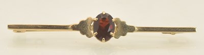 Lot 1391 - A 9ct yellow gold bar brooch with central set...
