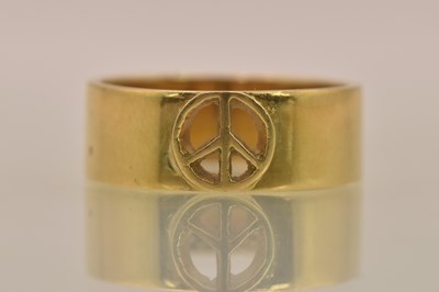 Lot 1204 - An 18ct yellow gold band ring with central...