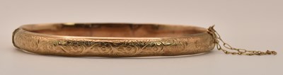 Lot 1430 - A yellow gold broken hollow hinged bracelet,...